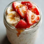 Easy overnight oats in mason jar with fresh fruit and maple drizzle