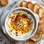 Ricotta dip with hot honey on white marble