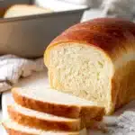 sliced sourdough sandwich bread on white board in clean kitchen