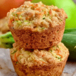 Two stacked zucchini carrot muffins with golden crust