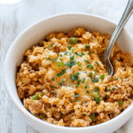 Served in a cozy white bowl, this sausage taco cauliflower rice skillet makes a comforting, low-carb dinner packed with flavor and color.