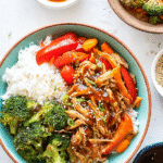 Overhead shot of easy crock pot teriyaki chicken bowl with rice, broccoli, peppers, and sauce on the side