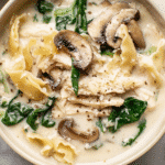 Creamy chicken lasagna soup with mushrooms, spinach, and Parmesan in a rich white sauce