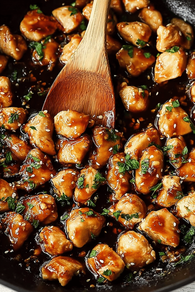 These skillet honey garlic chicken bites simmer in a rich, glossy sauce with fresh parsley for a quick and easy one-pan dinner recipe.