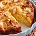 Close-up of a rustic Italian apple cake in a white dish