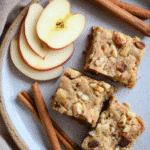 Apple brownies with nuts and apple slices on a plate