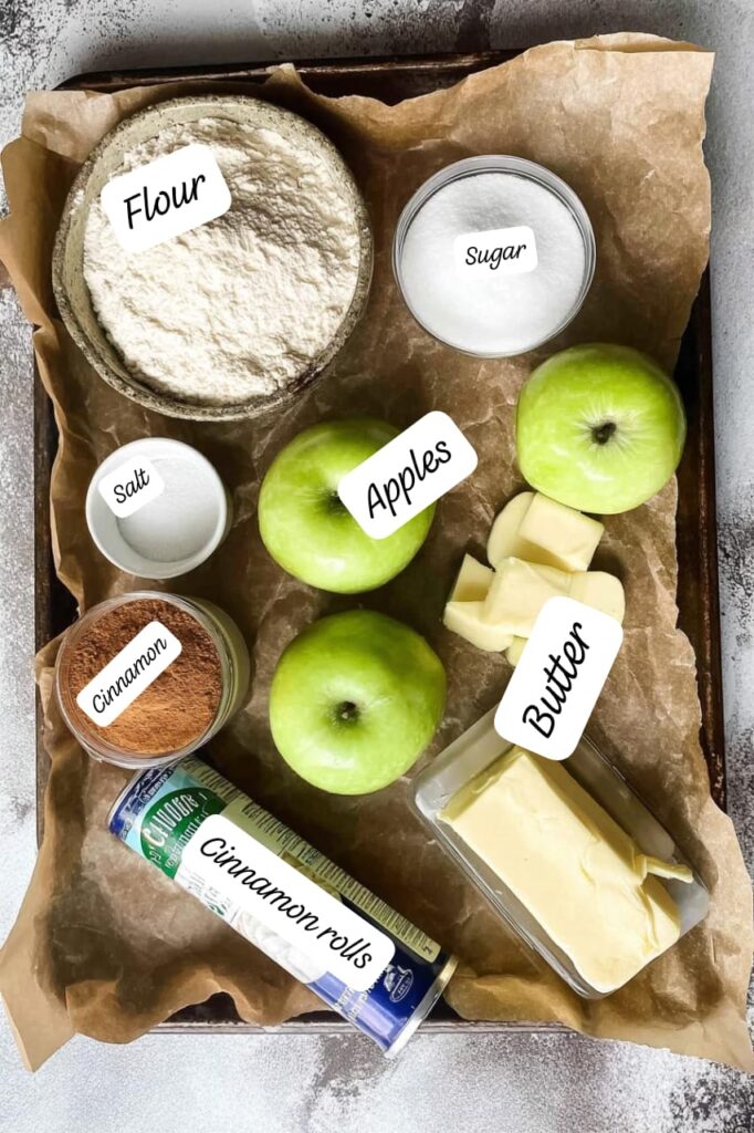 Cinnamon Roll Apple Pie ingredients arranged on a baking tray