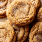 chewy pumpkin snickerdoodle cookies with sugar coating on parchment paper