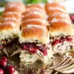 Turkey cranberry sliders with melted cheese on sesame seed buns
