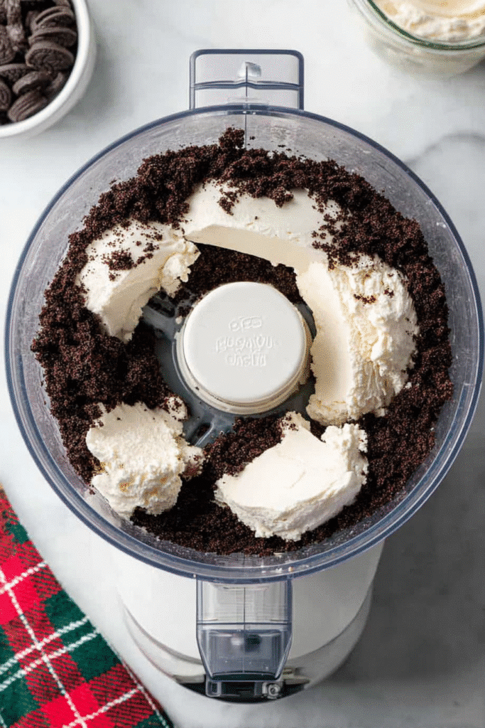 oreo crumbs and cream cheese in food processor for christmas oreo balls