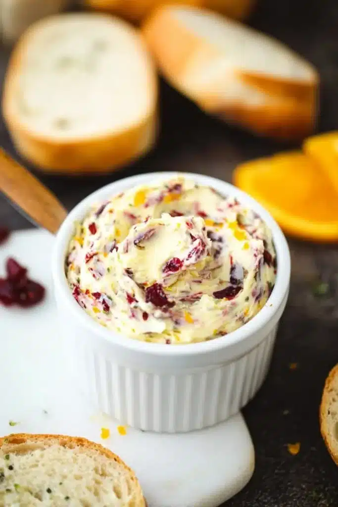 Cranberry honey butter in a white ramekin with sliced bread. Sweet, tangy spread ready in 10 minutes.