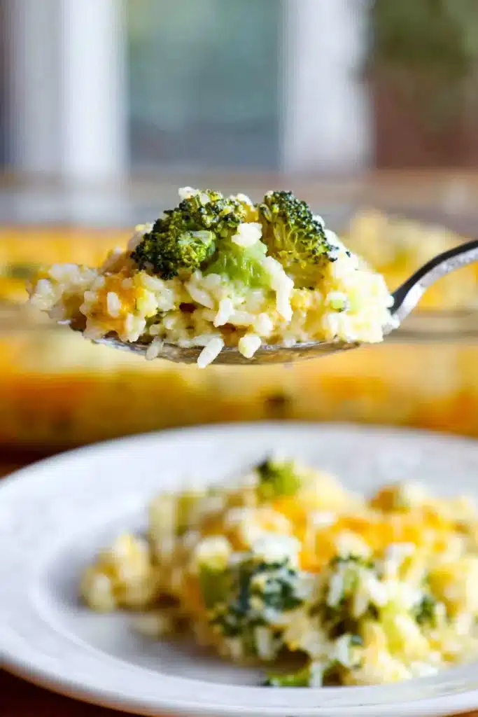 Spoonful of broccoli cheese rice casserole with creamy melted cheese