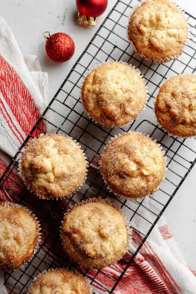 Easy Christmas Eggnog Muffins cooling on rack with festive towel