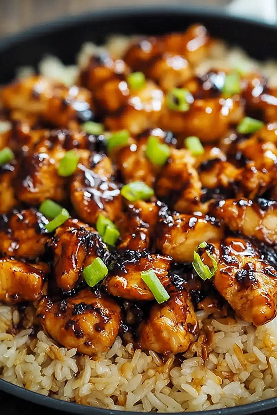 Honey BBQ Chicken Rice. Close-up of chicken with honey BBQ sauce and green onions on rice.
