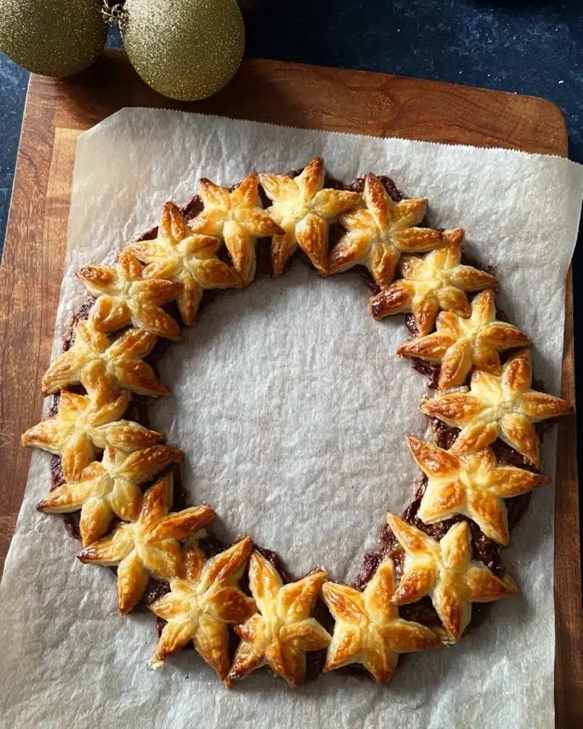 Baked Nutella puff pastry star wreath on parchment paper