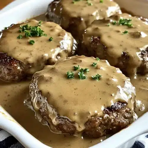 Amish Hamburger Steak Bake with creamy gravy and ground beef.