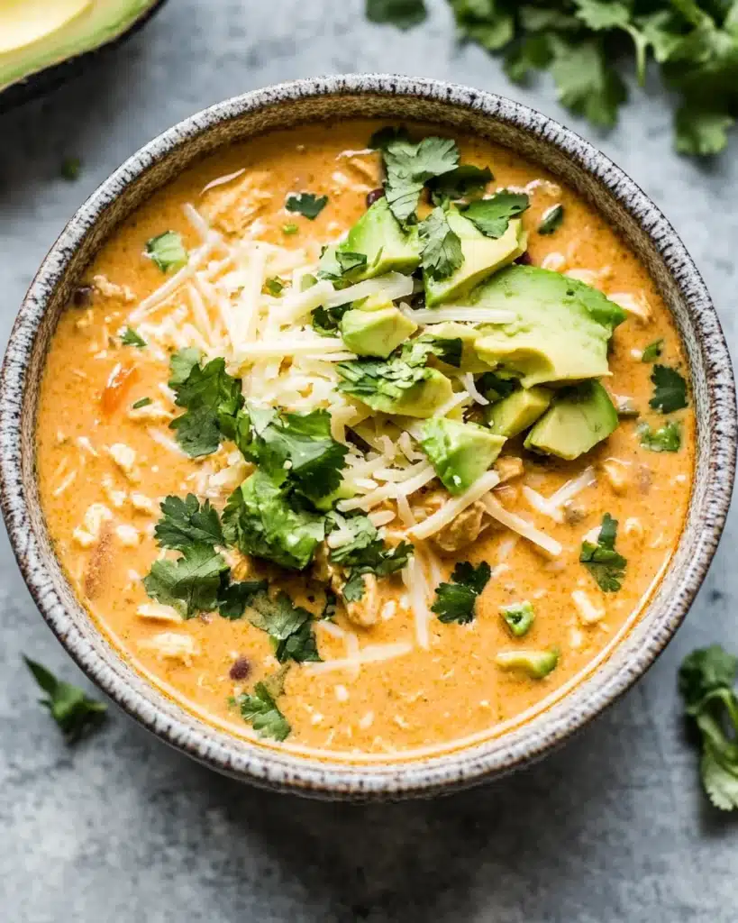 Delicious creamy white chicken chili with toppings ready to enjoy