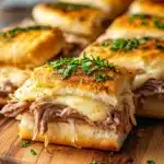 Delicious french dip sliders stacked, perfect for gatherings.