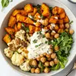 Delicious Glow Bowl recipe with roasted veggies and tahini yogurt sauce.