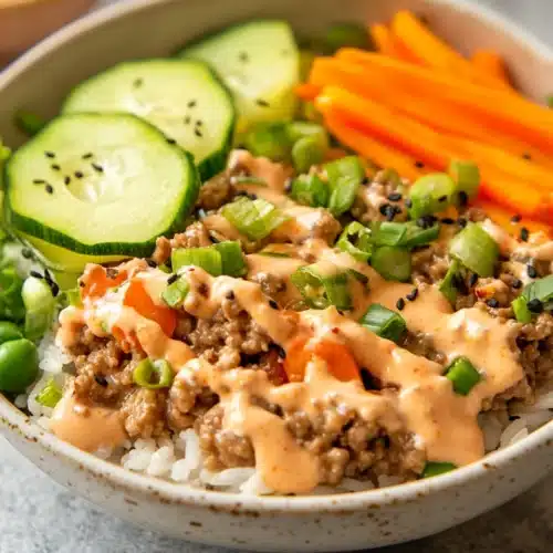 Ground Turkey Rice Bowls topped with veggies and sauce for a festive meal.