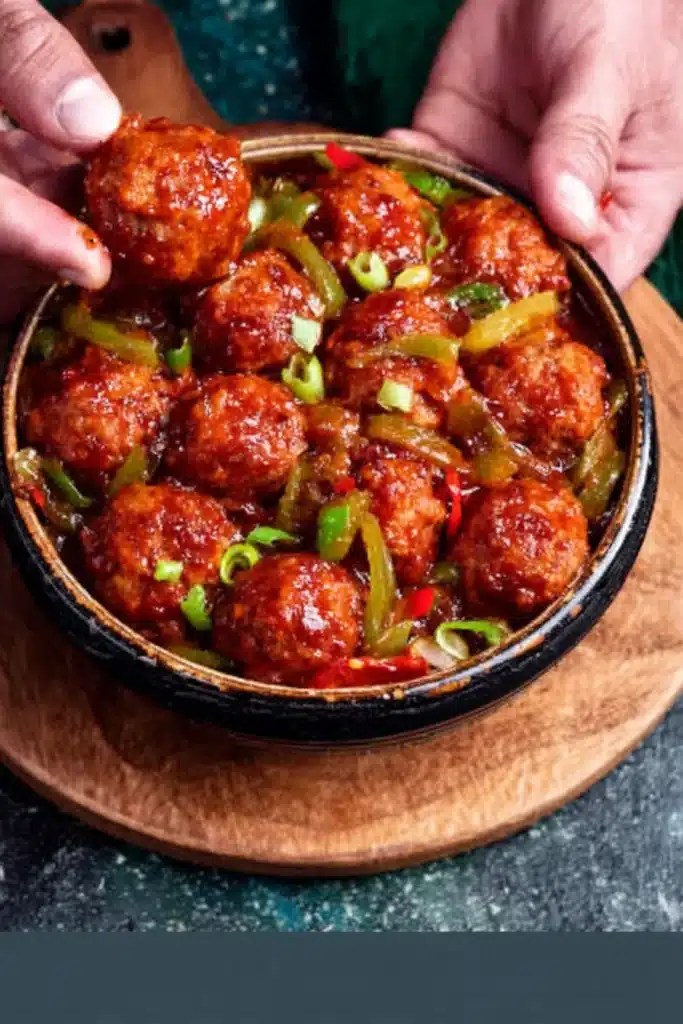 cabbage manchurian recipe in spicy sauce held in hands