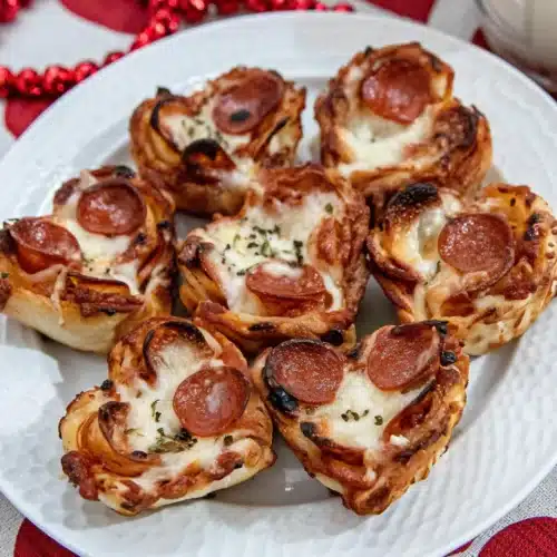 pizza roses for valentine’s day with pepperoni and cheese on white plate
