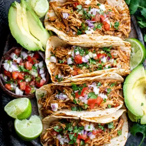 Delicious healthy slow cooker shredded chicken tacos ready to serve.