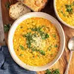 Delicious italian pastina soup garnished with parsley and cheese.