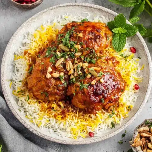Persian chicken served with rice, embodying rich flavors and warm spices