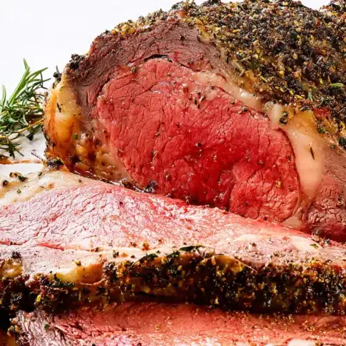 sliced prime rib with herb crust and juicy pink center