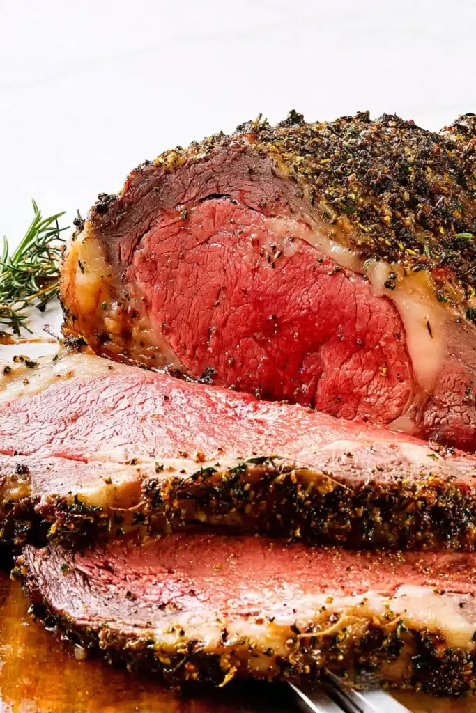 sliced prime rib with herb crust and juicy pink center