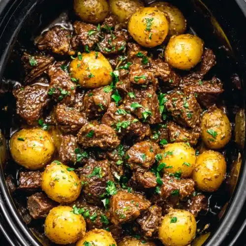 Delicious slow cooker garlic butter beef bites with potatoes.
