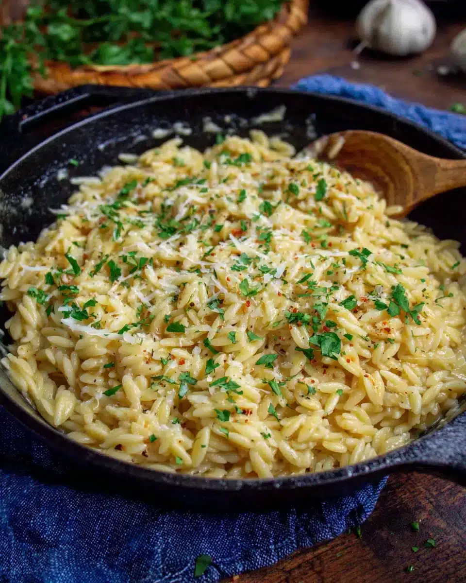 Creamy Garlic Parmesan Orzo pasta in a skillet, rich and comforting.
