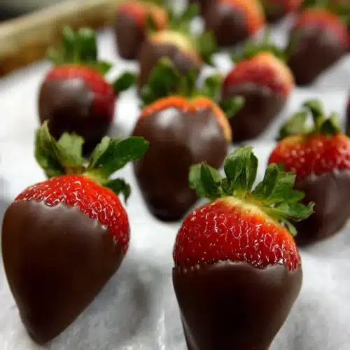 Delicious easy chocolate covered strawberries on wax paper