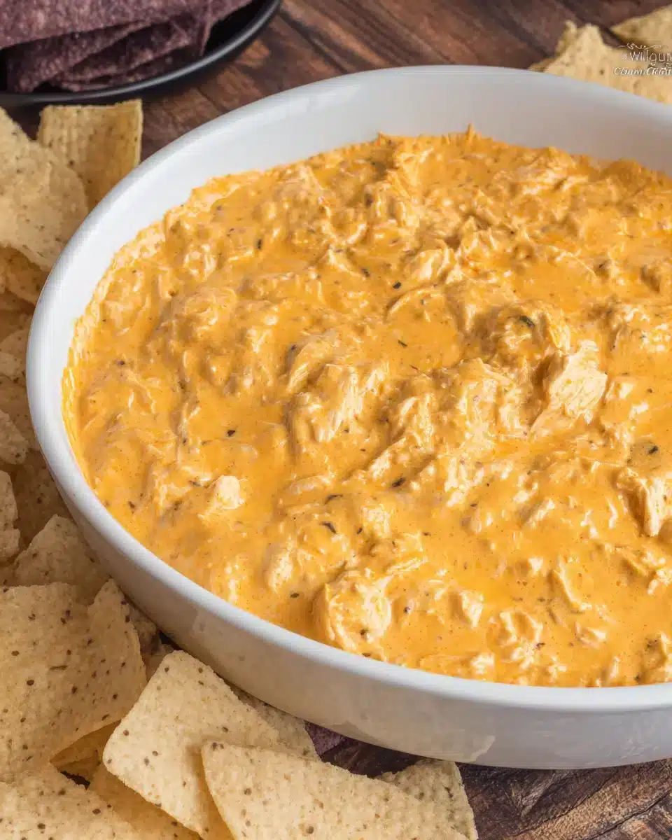 easy Crockpot Buffalo Chicken Dip with chips ready for dipping