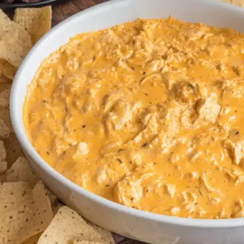 easy Crockpot Buffalo Chicken Dip with chips ready for dipping