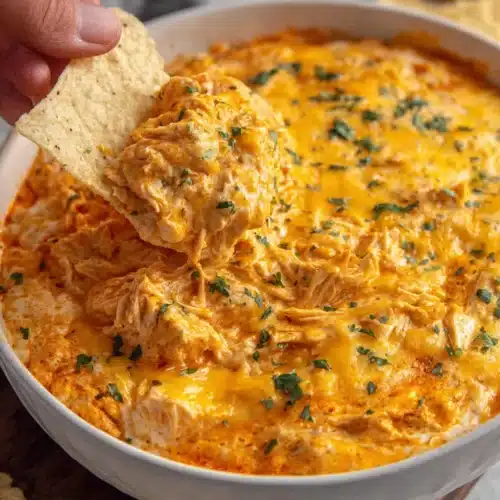 Game Day Buffalo Chicken Dip served with a chip for dipping.