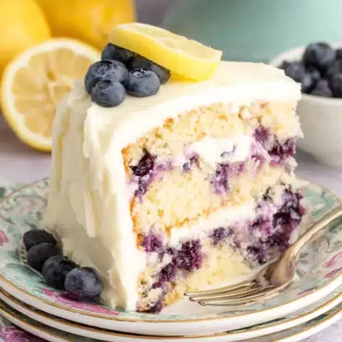 Delicious Lemon Blueberry Cake showcasing sweet blueberries and creamy frosting.