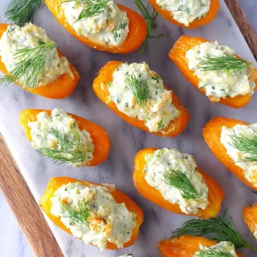 Colorful mini stuffed carrots filled with herb cream cheese