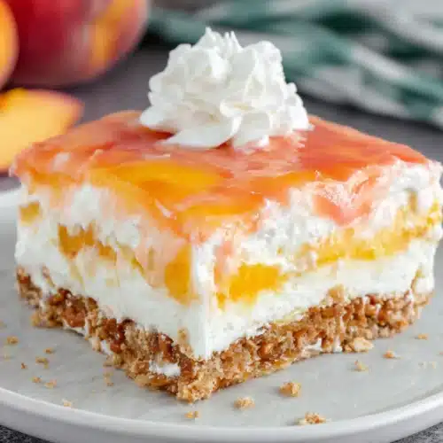 Delicious peach pretzel salad with layers of cream and gelatin.