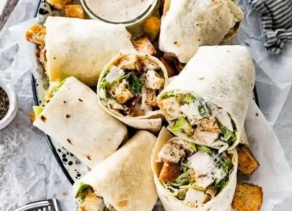 Delicious Chicken Caesar Wrap with grilled chicken, romaine lettuce, and Caesar dressing.