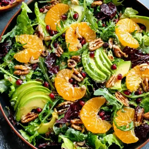 A vibrant mandarin orange salad with fresh ingredients.