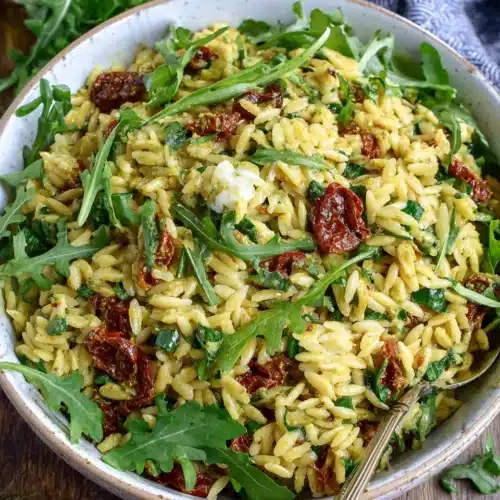 Delicious pesto orzo salad with sun-dried tomatoes, perfect for spring.