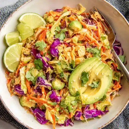 Shredded Thai salad with avocado and colorful vegetables.