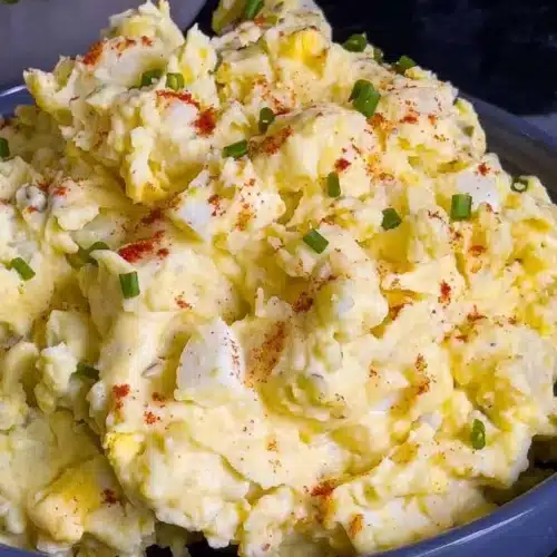Delicious Southern potato salad garnished with chives and paprika