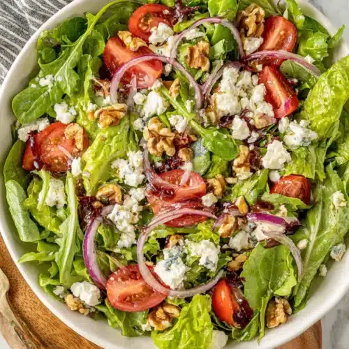Delicious spring mix salad with fresh ingredients including feta and walnuts.
