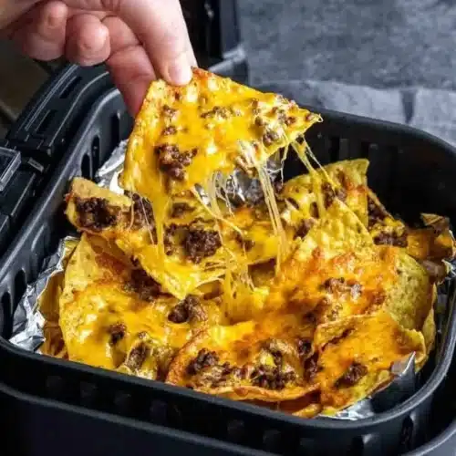 Deliciously crispy Air Fryer Nachos topped with cheese and jalapeños