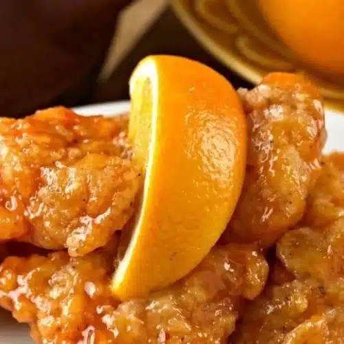 Delicious Air Fryer Orange Chicken plated with rice and vegetables