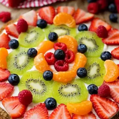 Delicious breakfast fruit pizza topped with assorted fresh fruits and yogurt