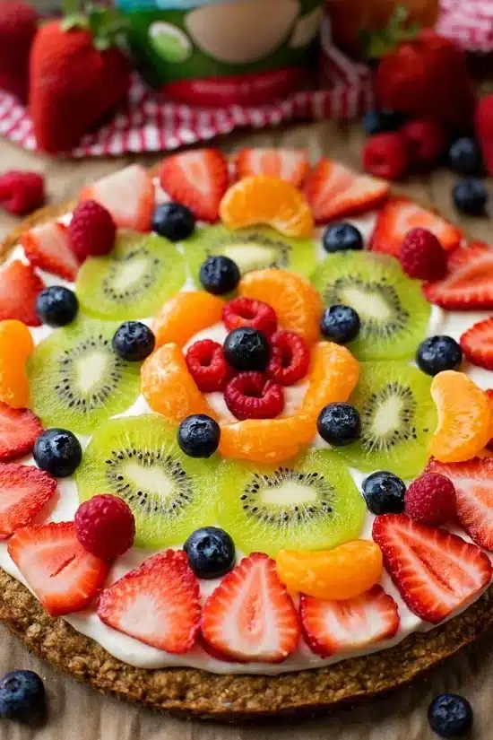 Delicious breakfast fruit pizza topped with assorted fresh fruits and yogurt